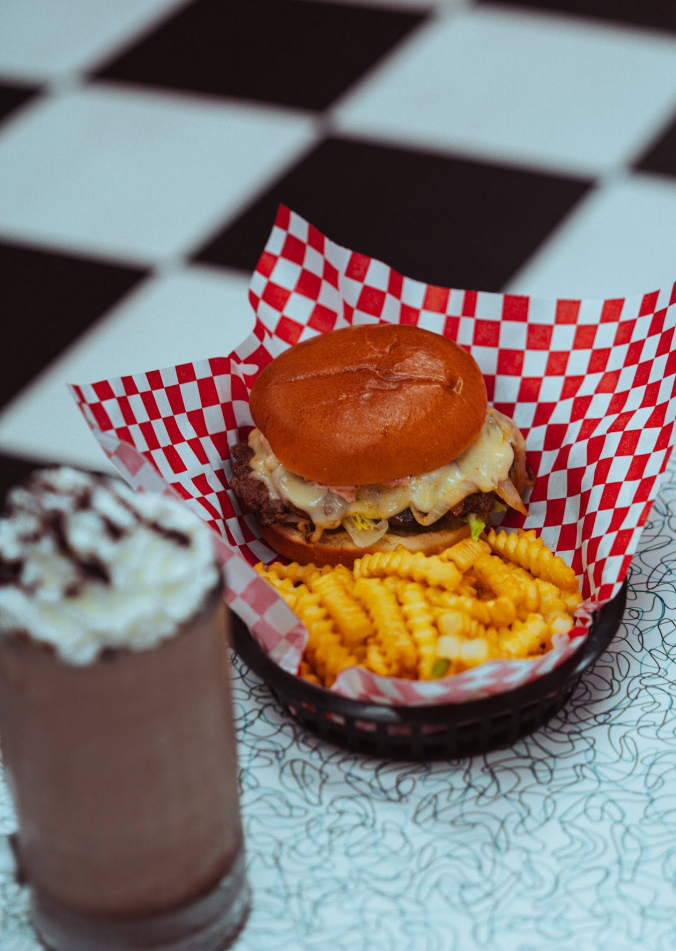 Smash burger with waffle fries and a chocolate shake