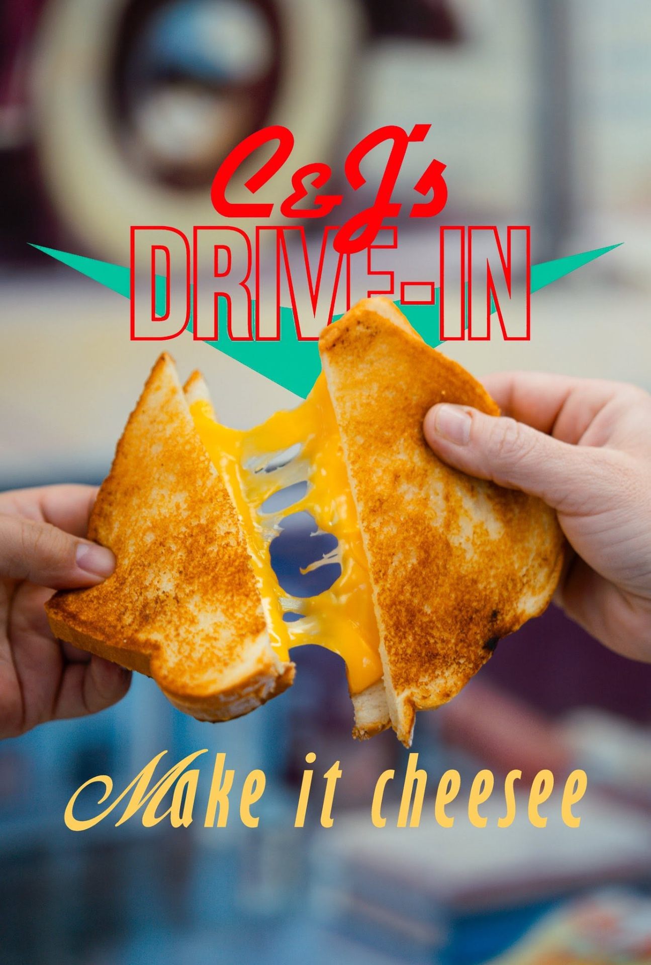 Hands pulling apart a melty grilled cheese