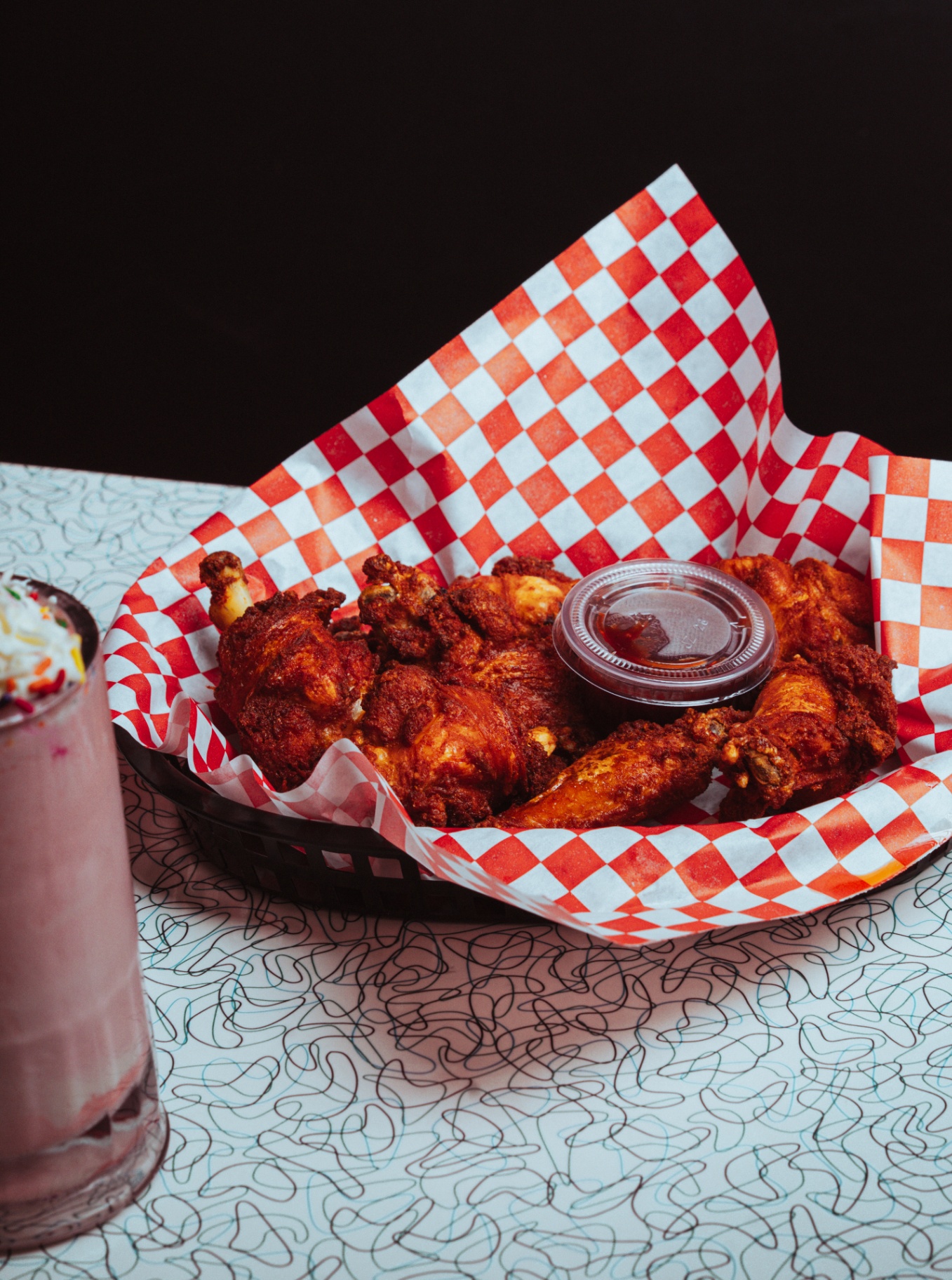 Basket of crispy fried wings with dipping sauce